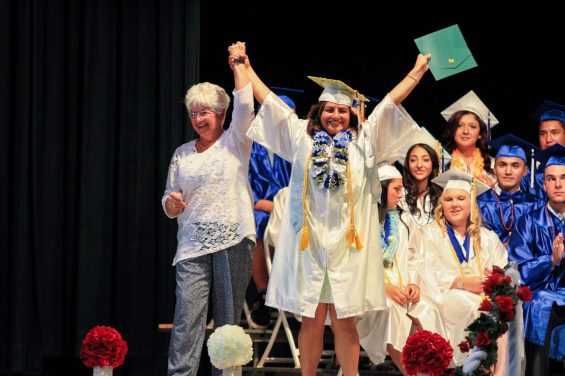 Person wearing cap and gown celebrating