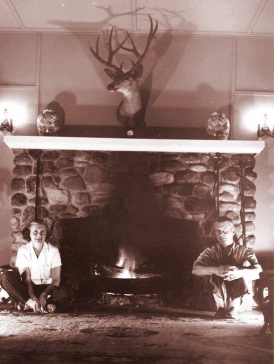 Leah and Carl in front of a fireplace