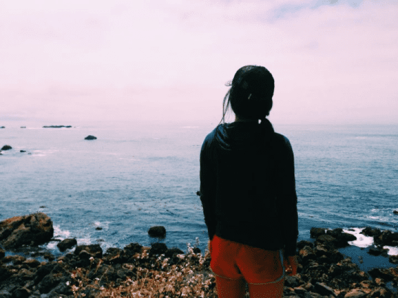 Person standing in front of ocean