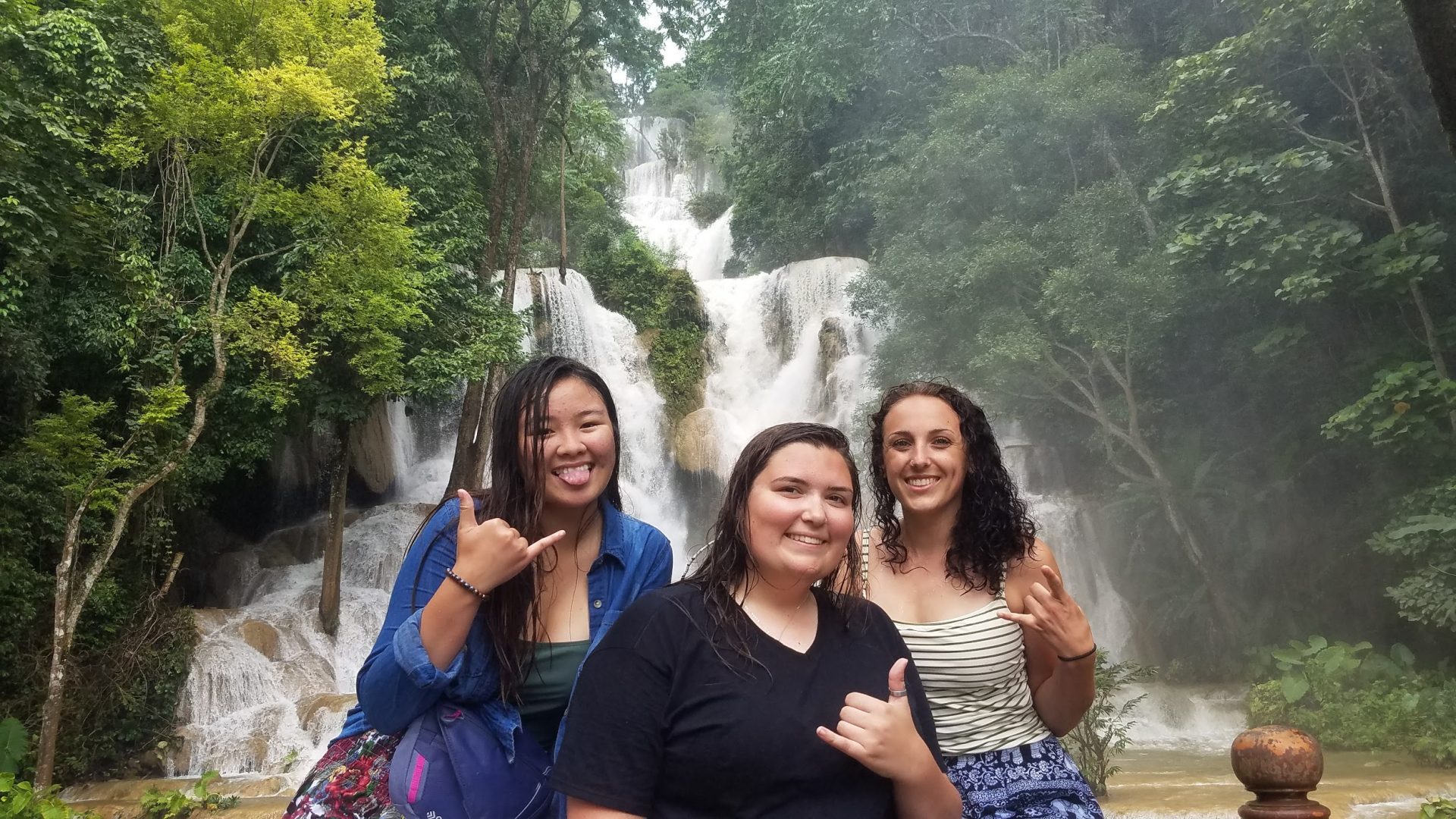 Group photo in front of waterfall