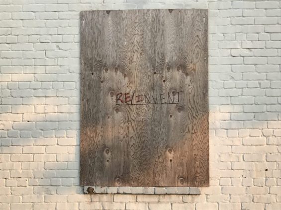 RE/Invent written on plywood