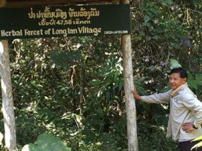 Person standing next to sign