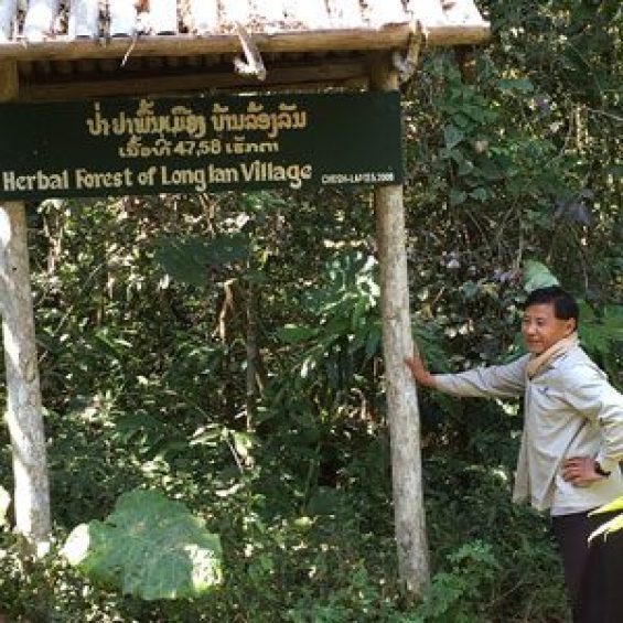 Person standing next to sign