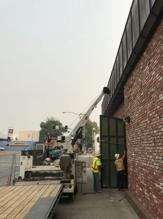 Construction workers removing a door