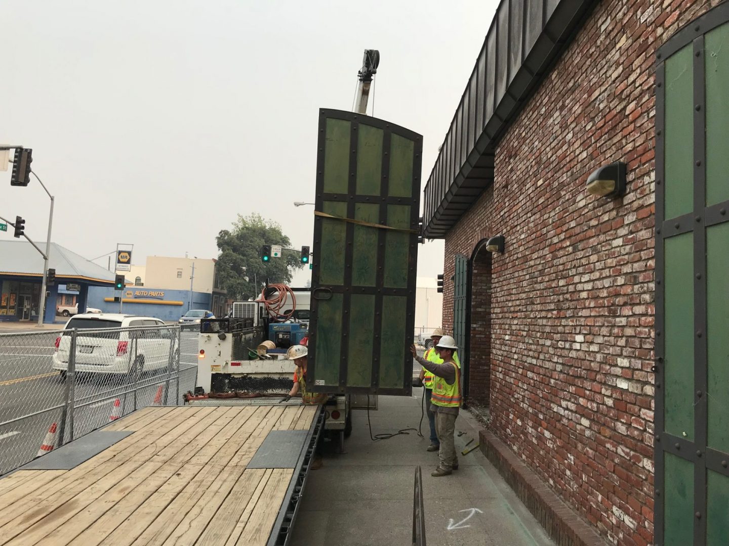 Construction workers loading material onto trailer