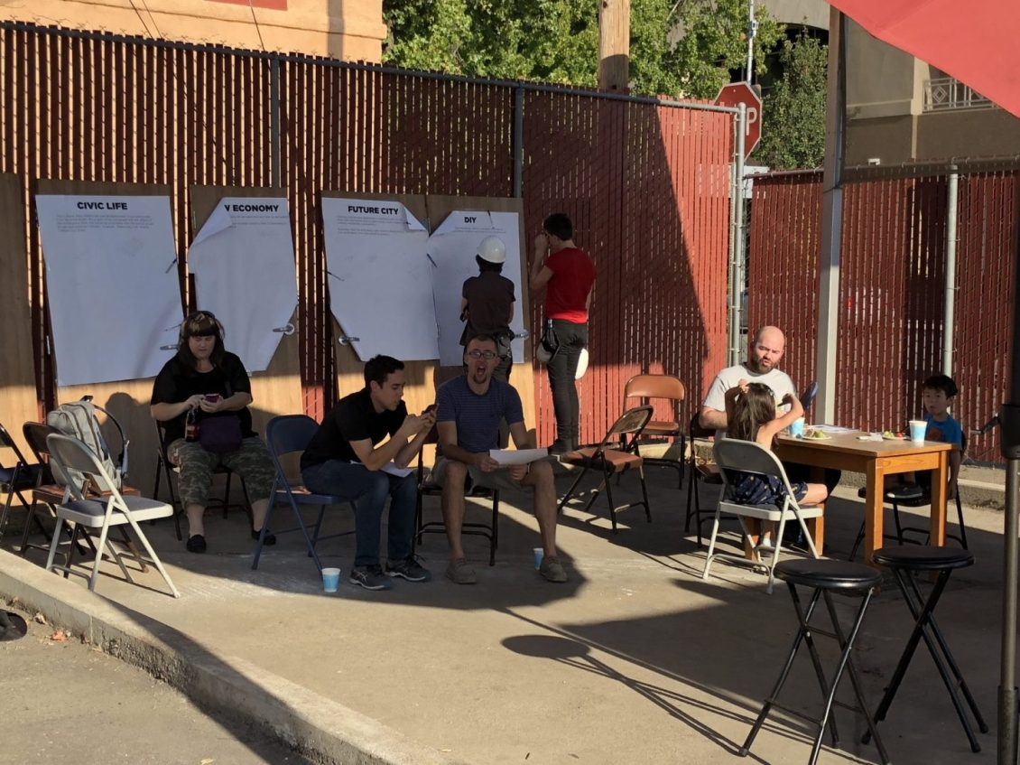 People sitting under umbrella shade