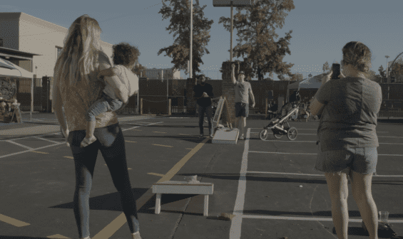 People playing cornhole