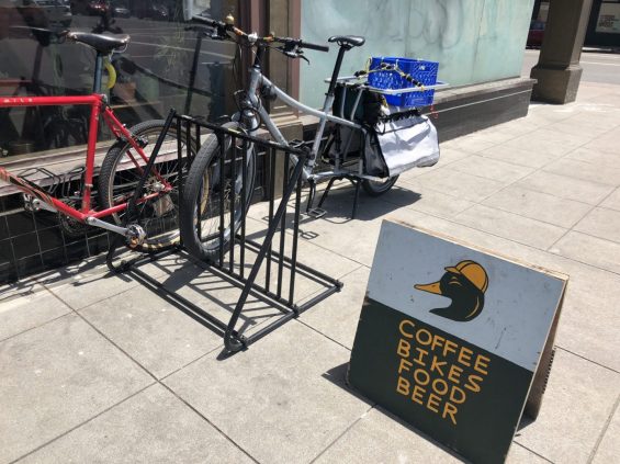 Bike on bike rack in front of cafe