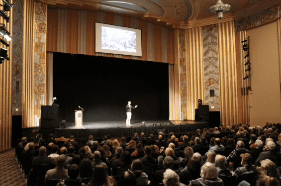 Person on a stage speaking