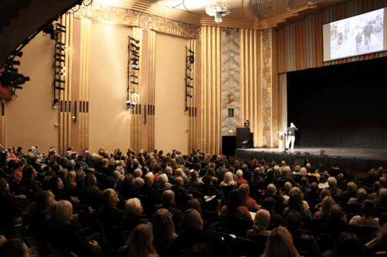 Person on a stage speaking