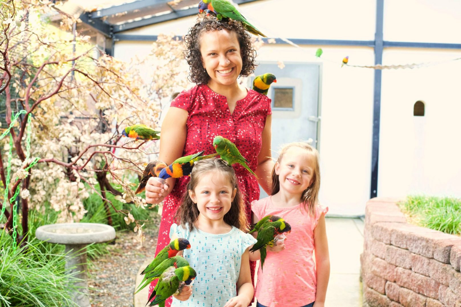 Woman and children holding birds