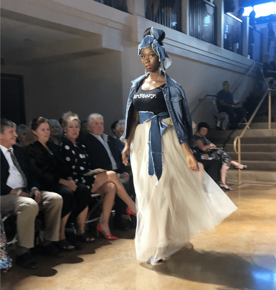 Woman walking down fashion show runway