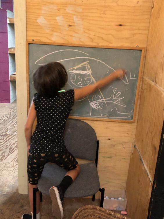 Child drawing with chalk