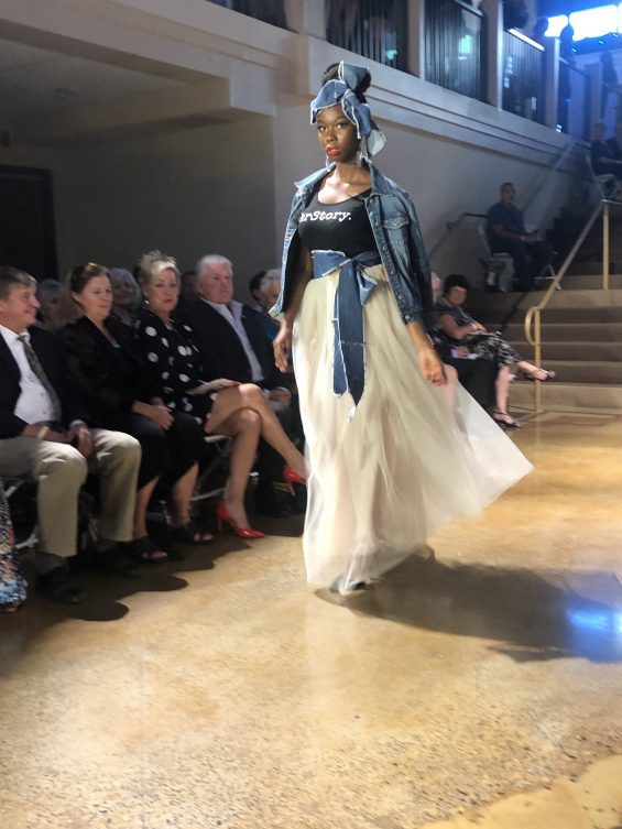 Woman walking down fashion show runway